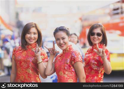 group of asian woman wearing chinese tradition clothes toothy smiling face happiness emotion and hand sign i love you