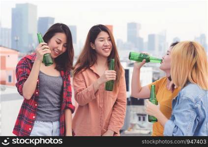 Group of asian women drinking at rooftop party, outdoors celebration