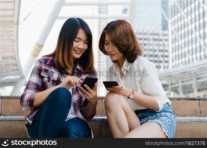 Group of Asian women using smartphone for direction and looking on location map while traveling in urban city in Bangkok, Thailand. Lifestyle tourist travel holiday in Thailand concept.