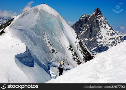 Group of backcountry skiers (ski touring), on background the Matterhorn, west alps, Europe.