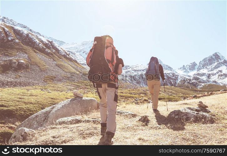 Group of backpackers hiking in mountains outdoor active lifestyle travel adventure vacations journey freedom Summer landscape Hike concept