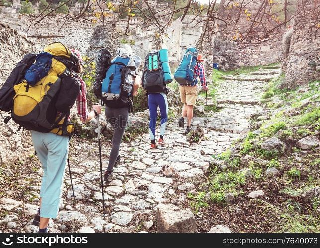 Group of backpackers hiking in mountains outdoor active lifestyle travel adventure vacations journey freedom Summer landscape Hike concept
