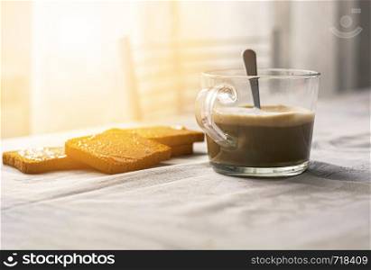 group of biscuits with jam spread with a cup of cappuccino on a table with the decorated tablecloth. Morning breakfast. Healthy food and lifestyle