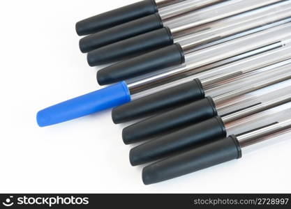 group of black pens with a blue one isolated on white