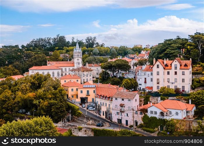Group of buildings in a village surrounded by forest trees in the old town near the Palace of Sintra. Lisbon, Portugal.