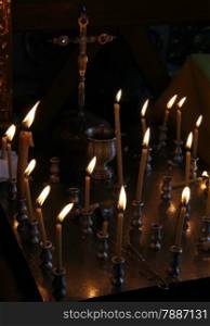 Group of burning candles in Ukrainian orthodox church