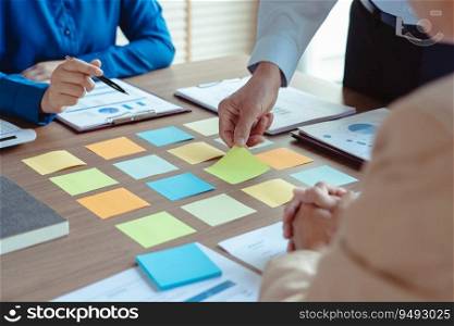 Group of business colleague read data in sticky notes to brainstorming and coworking new business.