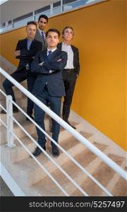 Group of Business man on the stairs with a yellow wall behind