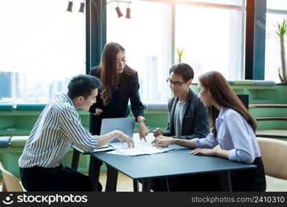 Group of business partners discussing new project at meeting in office room,Explaining idea and showing work plan.