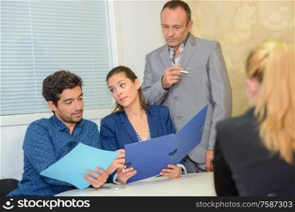 group of business people addressing office meeting