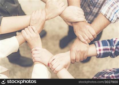 Group of business people crossed arms in pile for win. Stack of . Group of business people crossed arms in pile for win. Stack of hands. Cooperation concept. Group of business people crossed arms in pile for win. Stack of hands. Cooperation concept
