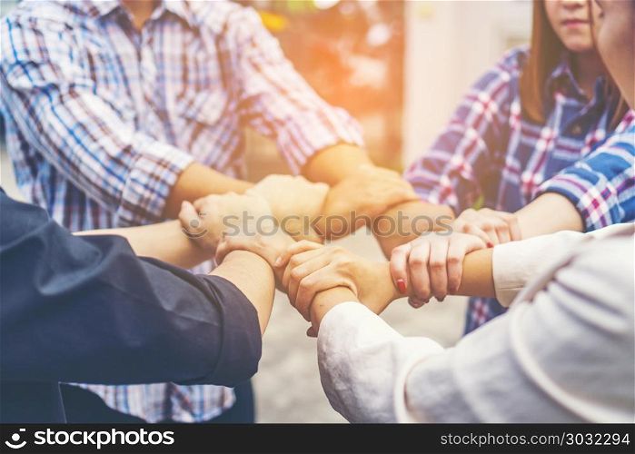 Group of business people crossed arms in pile for win. Stack of hands. Cooperation concept