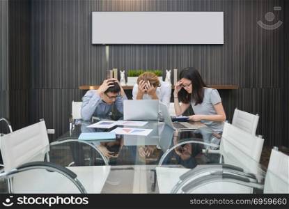 Group of business people depressed in a meeting room, sharing th. Group of business people depressed in a meeting room, sharing their ideas, Multi ethnic. Group of business people depressed in a meeting room, sharing their ideas, Multi ethnic