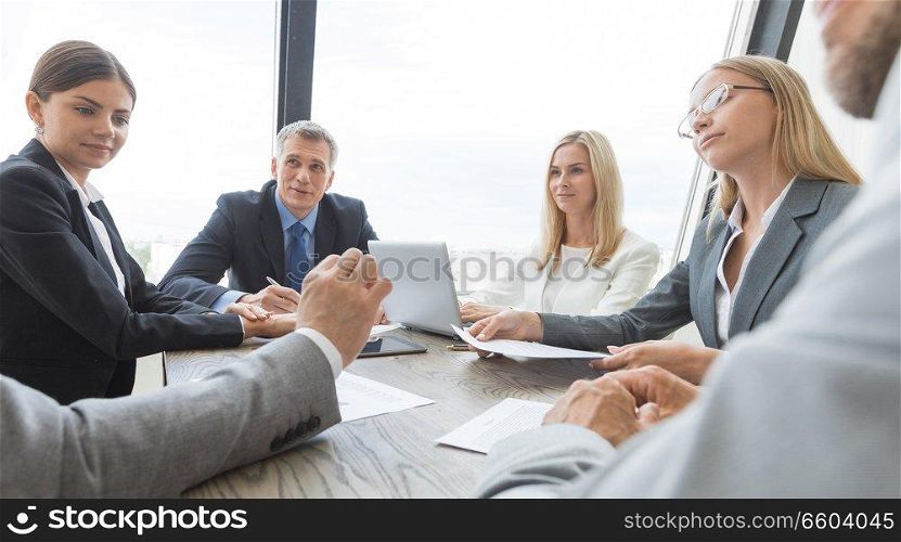 Group of Business people discussing a financial documents at meeting. Business people discussing a finance