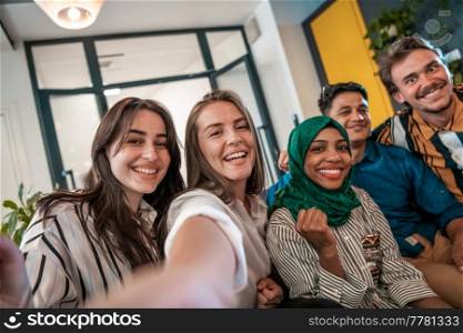 Group of business people during a break from the work taking selfie picture while enjoying free time in relaxation area at modern open plan startup office. Selective focus. High-quality photo. Group of business people during break from the work taking selfie picture while enjoying free time in relaxation area at modern open plan startup office. Selective focus