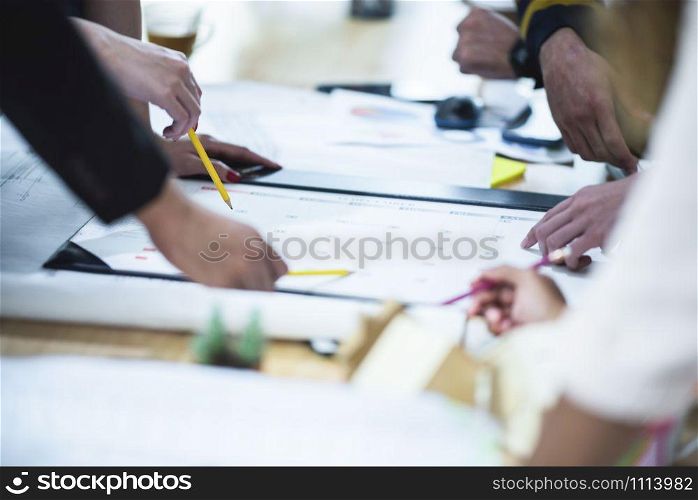 Group of business people hands working on wood desk in office top view.