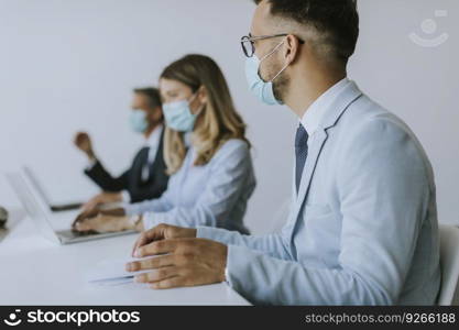 Group of business people have a meeting and working in the office and wear masks as protection from corona virus