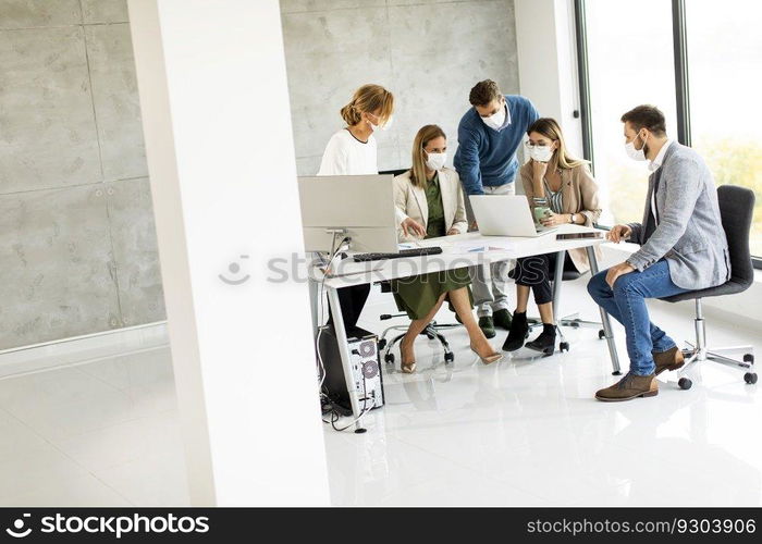 Group of business people have a meeting and working in the office and wear masks as protection from corona virus