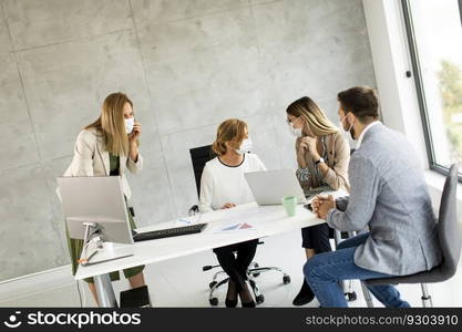 Group of business people have a meeting and working in the office and wear masks as protection from corona virus