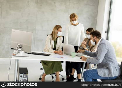 Group of business people have a meeting and working in the office and wear masks as protection from corona virus