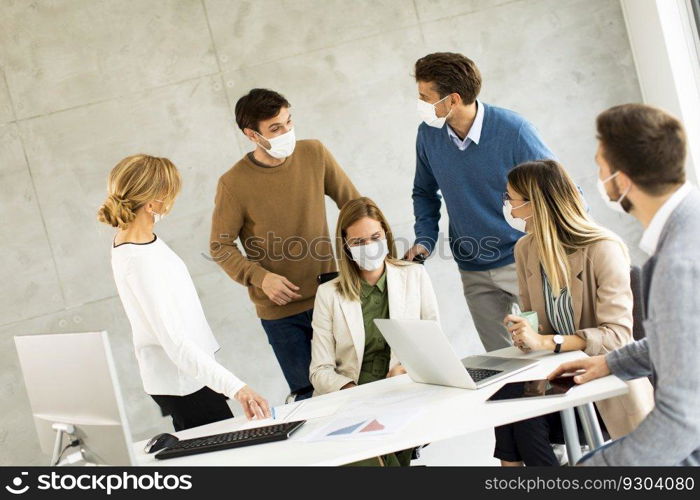 Group of business people have a meeting and working in the office and wear masks as protection from corona virus