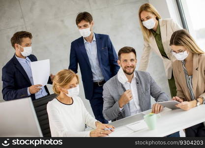 Group of business people have a meeting and working in the office and wear masks as protection from coronavirus