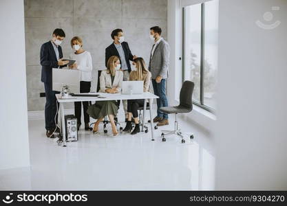 Group of business people have a meeting and working in the office and wear masks as protection from corona virus