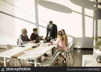 Group of business people have a meeting and working in the office and wear masks as protection from corona virus