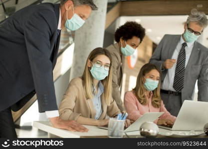 Group of business people have a meeting and working in the office and wear masks as protection from corona virus