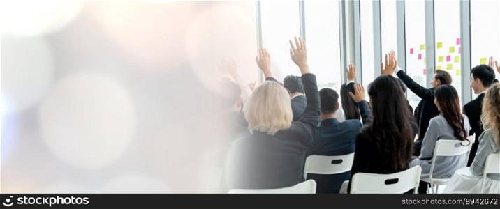 Group of business people meeting in a seminar conference widen view . Audience listening to instructor in employee education training session . Office worker community summit forum with speaker .. Group of business people meeting in a seminar conference widen view
