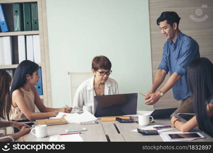 Group of business people meeting in conference room. Asian businessman speech, present teamwork partnership. Happy business people meeting present graph chart investment, business data in meeting room