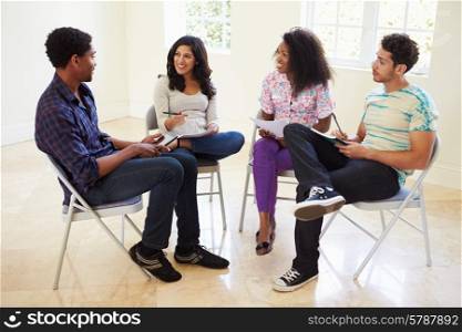 Group Of Business People Sitting On Chairs Having Meeting