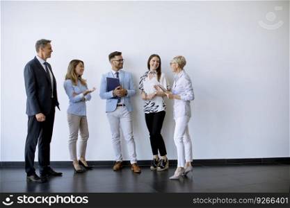 Group of business people standing by the wall in the office