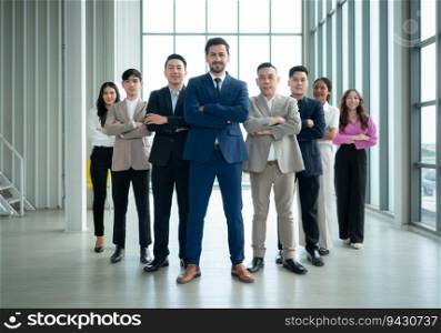 Group of business people standing in line in conference room used for meeting in modern office