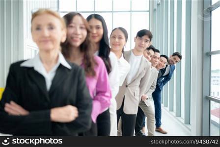 Group of business people standing in line in conference room used for meeting in modern office, Focus on the last person