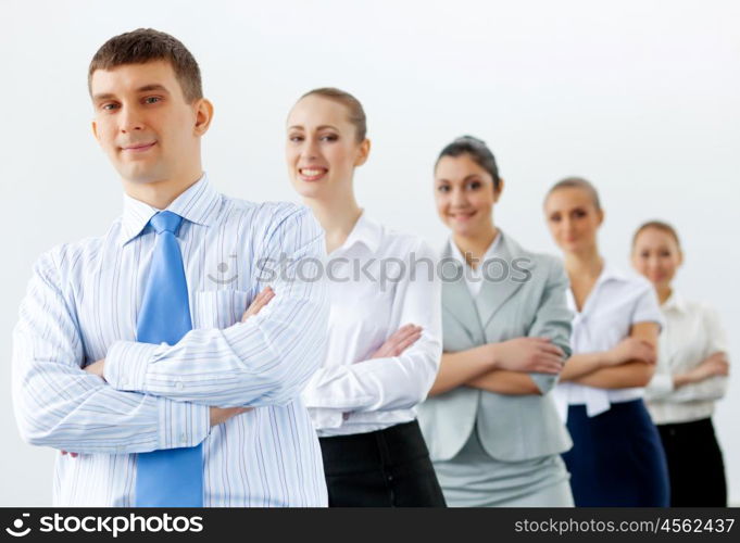 Group of business people standing in row. Group of businesspeople smiling standing with arms crossed