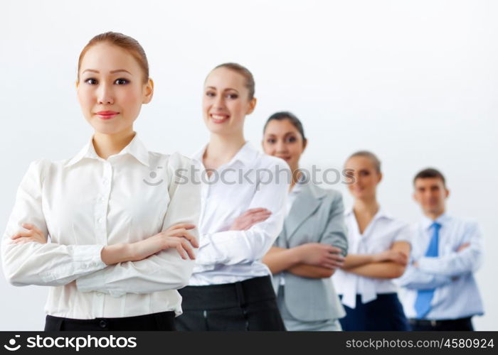 Group of business people standing in row. Group of businesspeople smiling standing with arms crossed