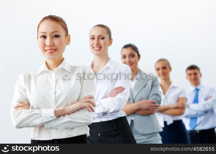 Group of business people standing in row. Group of businesspeople smiling standing with arms crossed