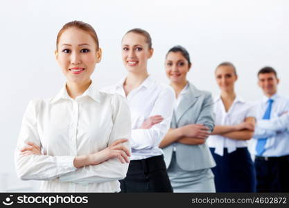 Group of business people standing in row. Group of businesspeople smiling standing with arms crossed