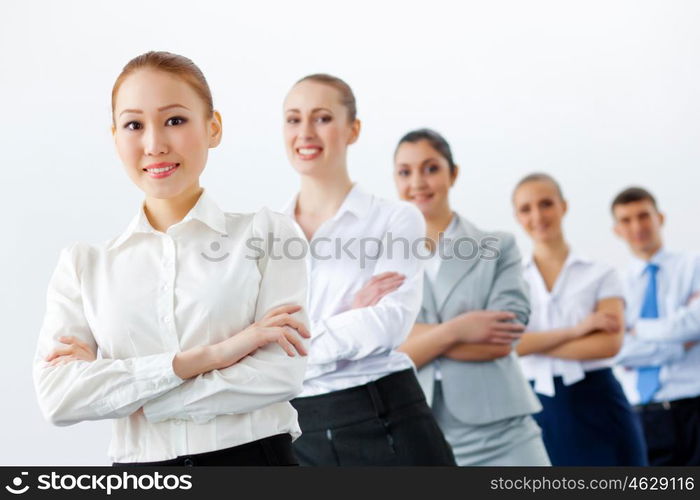 Group of business people standing in row. Group of businesspeople smiling standing with arms crossed