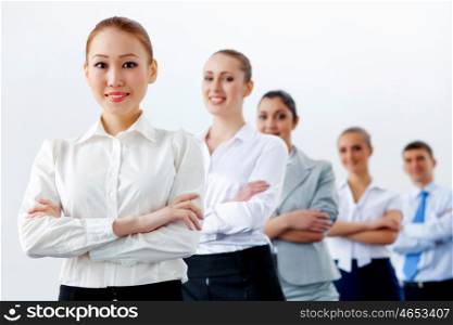 Group of business people standing in row. Group of businesspeople smiling standing with arms crossed