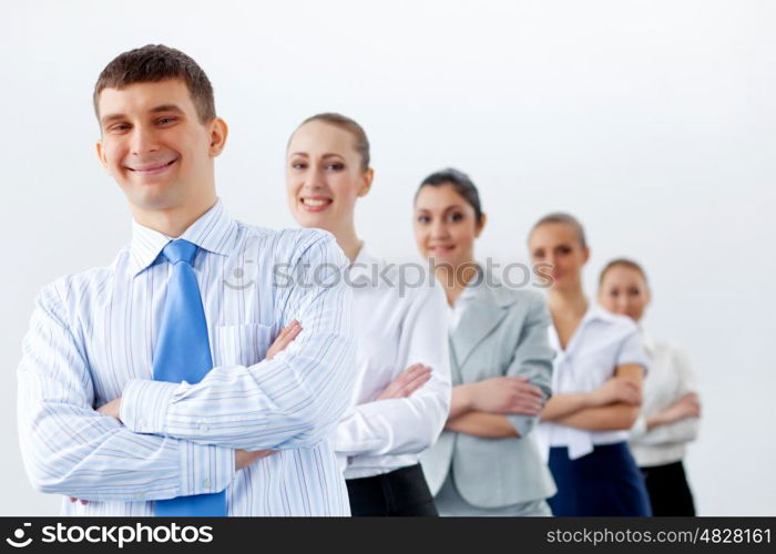 Group of business people standing in row. Group of businesspeople smiling standing with arms crossed