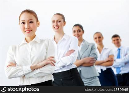 Group of business people standing in row. Group of businesspeople smiling standing with arms crossed