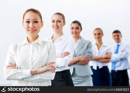 Group of business people standing in row. Group of businesspeople smiling standing with arms crossed