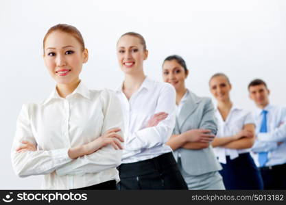 Group of business people standing in row. Group of businesspeople smiling standing with arms crossed