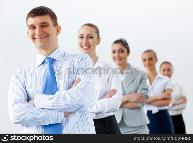 Group of business people standing in row. Group of businesspeople smiling standing with arms crossed