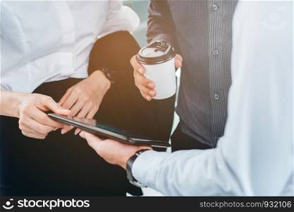Group of Business people talking businessman working on digital tablet in outdoor after work