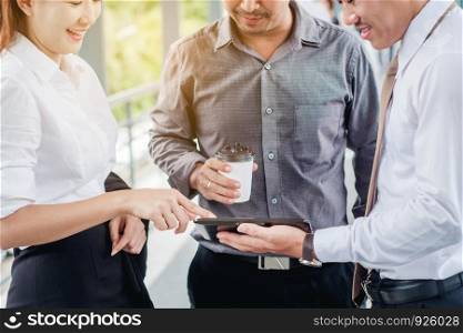 Group of Business people talking withbusinessman working on digital tablet in outdoor after work