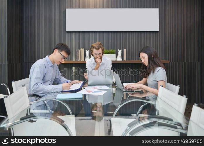 Group of business people thinking in a meeting room, sharing the. Group of business people thinking in a meeting room, sharing their ideas, Multi ethnic. Group of business people thinking in a meeting room, sharing their ideas, Multi ethnic