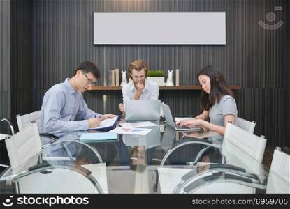 Group of business people thinking in a meeting room, sharing the. Group of business people thinking in a meeting room, sharing their ideas, Multi ethnic. Group of business people thinking in a meeting room, sharing their ideas, Multi ethnic